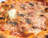 Eine knusprige Pizza Romana mit geschmolzenem Käse, Tomatensauce und dunklen, würzigen Belägen. Was ist drauf?