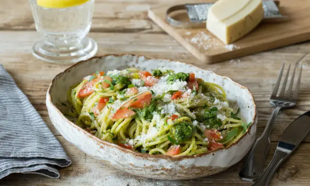 Spaghetti mit frischem Sauerampfer Pesto, Tomatenstücken und geriebenem Parmesan. Ein erfrischendes Gericht, das Lust auf mehr macht.
